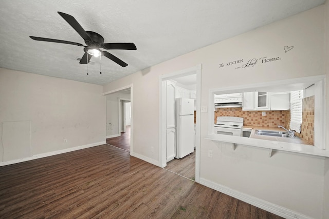 606 W 7th St, Freeport, TX 77541 - kitchen featuring white appliances, white cabinets, glass insert cabinets, wood finished floors, and decorative backsplash