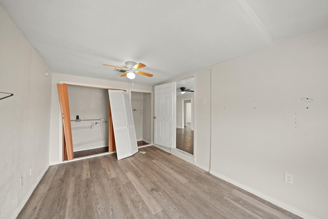 606 W 7th St, Freeport, TX 77541 - unfurnished bedroom with wood finished floors, a closet, and a ceiling fan