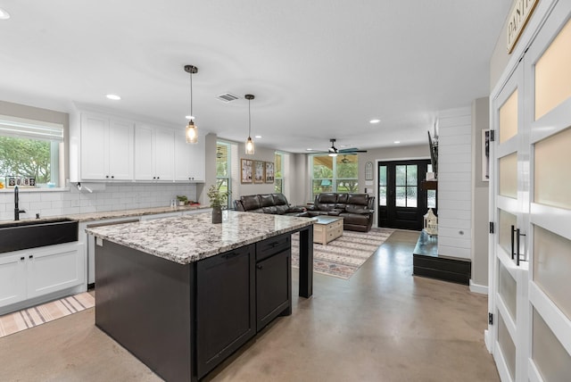 4439 W Bayshore Rd, Anahuac, TX 77514 - kitchen with white cabinets, plenty of natural light, and recessed lighting
