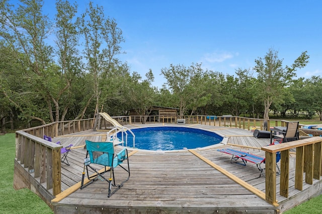 4439 W Bayshore Rd, Anahuac, TX 77514 - view of pool with a deck and view of wooded area