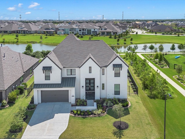 11319 Flying Admiral Dr, Cypress, TX 77433 - view of front of house featuring a residential view, concrete driveway, a garage, a standing seam roof, and a front lawn