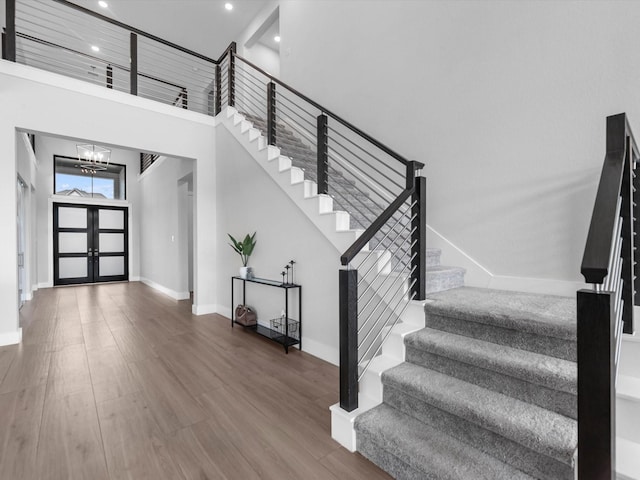 11319 Flying Admiral Dr, Cypress, TX 77433 - entrance foyer featuring stairs, a chandelier, recessed lighting, a towering ceiling, and wood finished floors