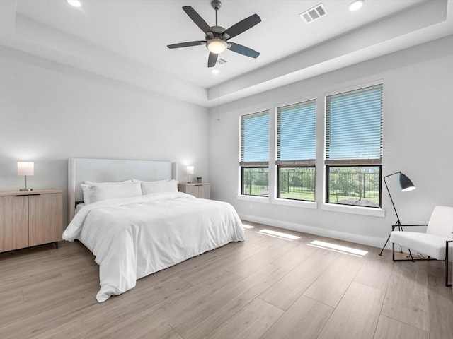 11319 Flying Admiral Dr, Cypress, TX 77433 - bedroom with light wood-style flooring, recessed lighting, a raised ceiling, and a ceiling fan