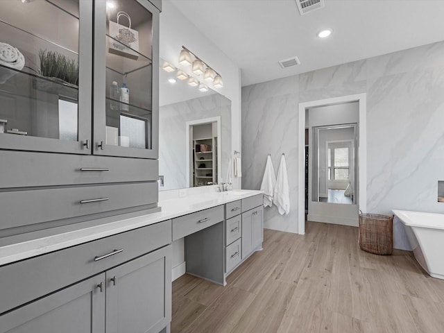 11319 Flying Admiral Dr, Cypress, TX 77433 - full bath featuring a soaking tub, vanity, wood finished floors, a spacious closet, and recessed lighting