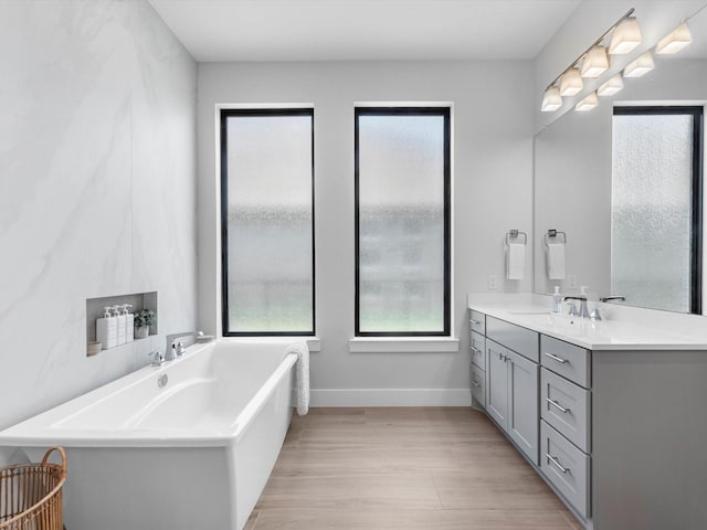 11319 Flying Admiral Dr, Cypress, TX 77433 - bathroom featuring a freestanding tub, vanity, and wood finished floors