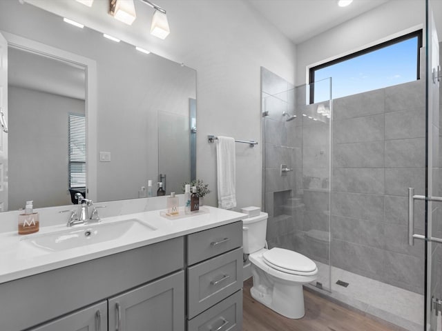11319 Flying Admiral Dr, Cypress, TX 77433 - full bathroom featuring vanity, tiled shower, and wood finished floors