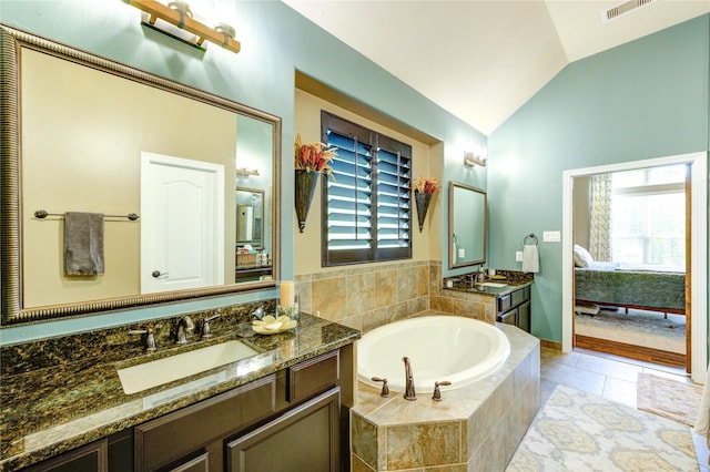 7003 Fall Creek Ln, Missouri City, TX 77459 - ensuite bathroom with lofted ceiling, a bath, vanity, and plenty of natural light