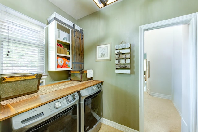 7003 Fall Creek Ln, Missouri City, TX 77459 - laundry area featuring washing machine and clothes dryer and light carpet