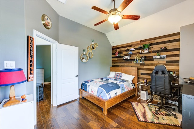 7003 Fall Creek Ln, Missouri City, TX 77459 - bedroom featuring wood finished floors, vaulted ceiling, wooden walls, a ceiling fan, and an office area