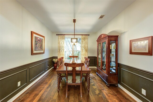 7003 Fall Creek Ln, Missouri City, TX 77459 - dining area with a wainscoted wall, dark wood finished floors, and a decorative wall