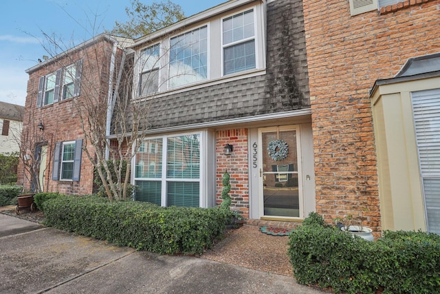 6355 Del Monte Dr Unit 64, Houston, TX 77057 - view of front of house featuring brick siding and a shingled roof