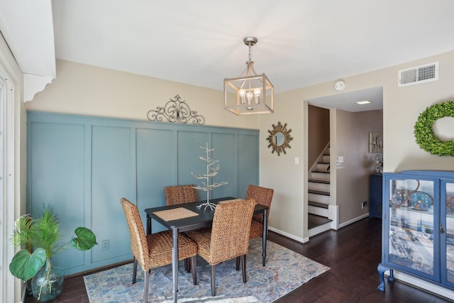 6355 Del Monte Dr Unit 64, Houston, TX 77057 - dining area featuring a decorative wall, stairs, a chandelier, dark wood finished floors, and wainscoting