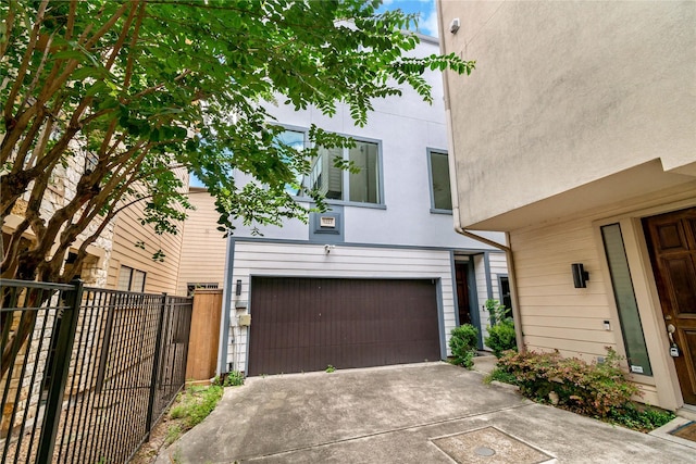 5223 Eigel St, Houston, TX 77007 - view of front of house featuring an attached garage, stucco siding, and concrete driveway