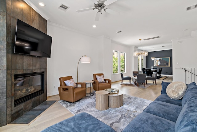 5223 Eigel St, Houston, TX 77007 - living room featuring light wood-style flooring, a tile fireplace, ornamental molding, a ceiling fan, and recessed lighting