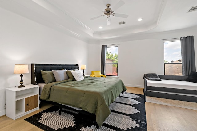 5223 Eigel St, Houston, TX 77007 - bedroom with a tray ceiling, light wood-style flooring, crown molding, recessed lighting, and a ceiling fan