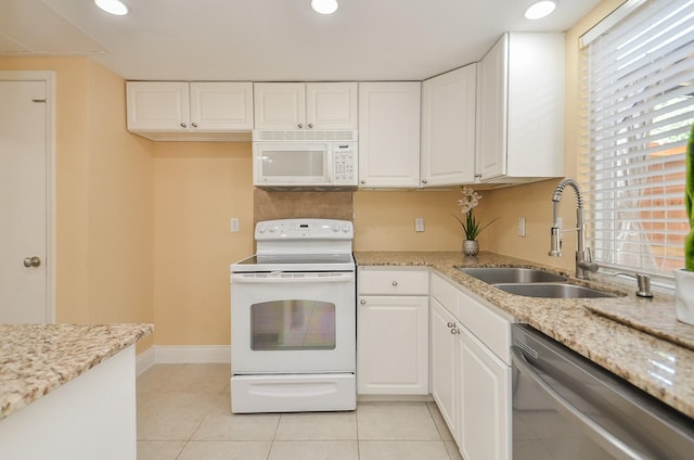 14707 Barryknoll Ln Unit 168, Houston, TX 77079 - kitchen featuring white appliances, white cabinetry, light tile patterned floors, light stone countertops, and recessed lighting