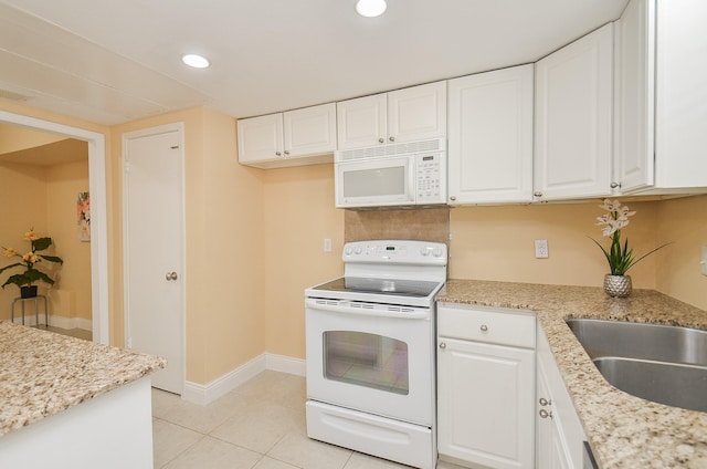 14707 Barryknoll Ln Unit 168, Houston, TX 77079 - kitchen featuring white appliances, white cabinetry, recessed lighting, light tile patterned floors, and light stone countertops