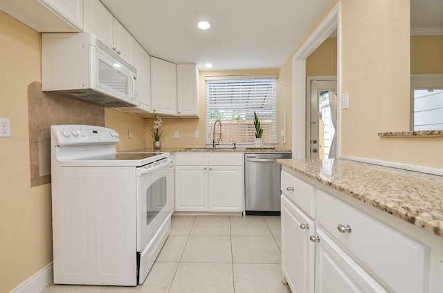14707 Barryknoll Ln Unit 168, Houston, TX 77079 - kitchen featuring white appliances, white cabinets, light tile patterned flooring, light stone counters, and recessed lighting