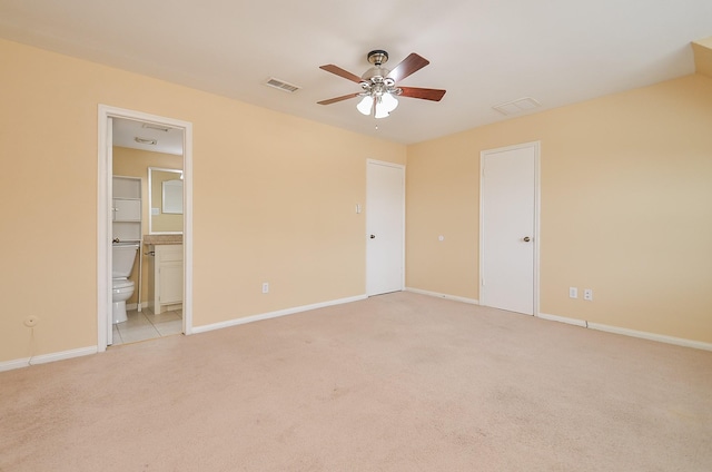 14707 Barryknoll Ln Unit 168, Houston, TX 77079 - unfurnished bedroom featuring light carpet, connected bathroom, and a ceiling fan