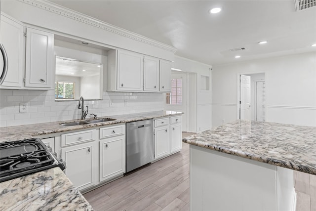 10906 Keese Dr, Houston, TX 77089 - kitchen with stainless steel dishwasher, decorative backsplash, white cabinetry, light wood-style floors, and light stone counters
