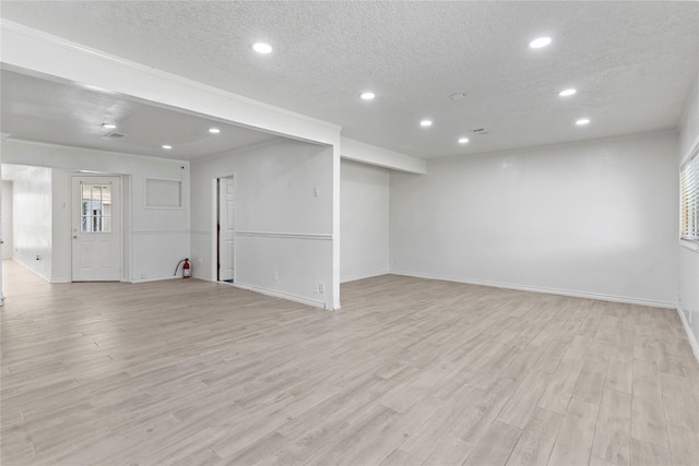 10906 Keese Dr, Houston, TX 77089 - unfurnished living room featuring recessed lighting, light wood-type flooring, and a textured ceiling