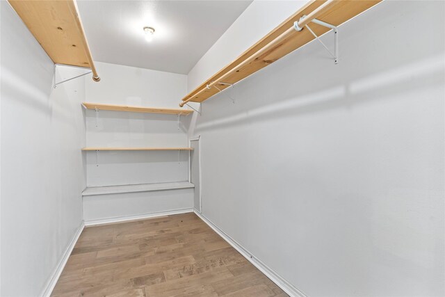 10906 Keese Dr, Houston, TX 77089 - walk in closet featuring wood finished floors