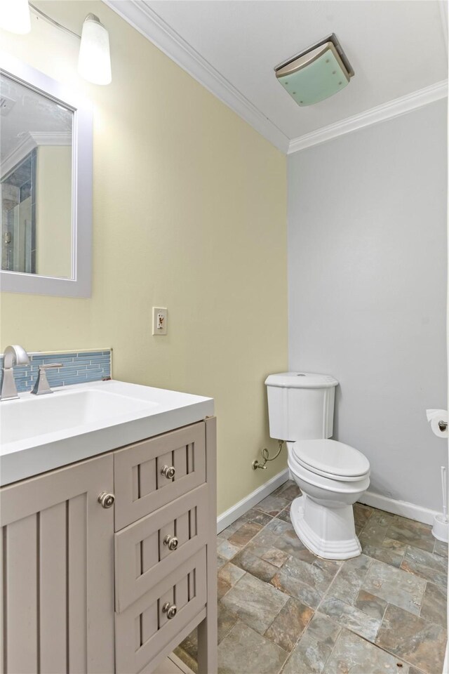 10906 Keese Dr, Houston, TX 77089 - bathroom with crown molding, vanity, stone tile floors, and decorative backsplash