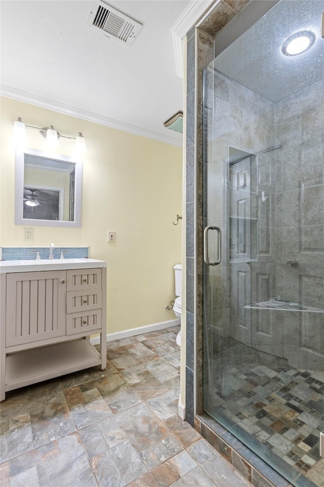 10906 Keese Dr, Houston, TX 77089 - bathroom featuring ornamental molding, vanity, a shower stall, stone finish floors, and ceiling fan