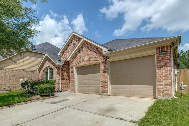 16223 Cotton Grove Ln, Houston, TX 77044 - ranch-style house with brick siding, driveway, a shingled roof, and an attached garage