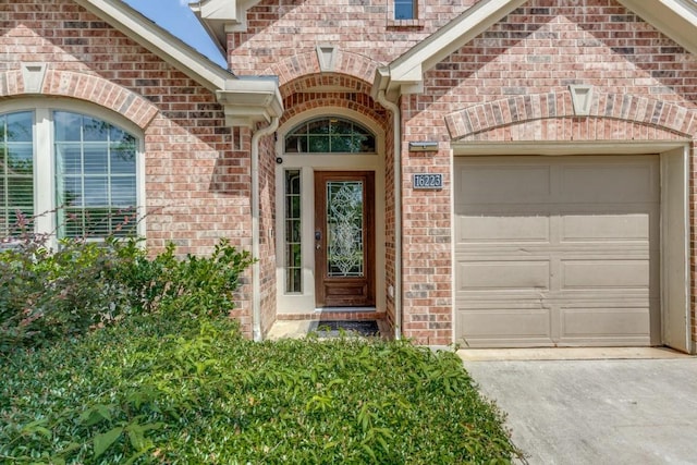 16223 Cotton Grove Ln, Houston, TX 77044 - property entrance with driveway, brick siding, and a garage