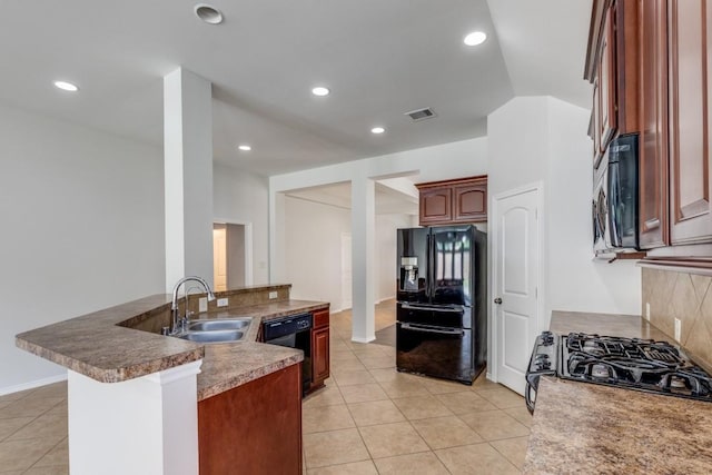 16223 Cotton Grove Ln, Houston, TX 77044 - kitchen with black appliances, light tile patterned floors, and recessed lighting