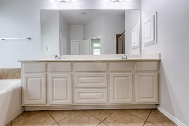 16223 Cotton Grove Ln, Houston, TX 77044 - bathroom featuring tile patterned floors, double vanity, a garden tub, and a shower with shower door
