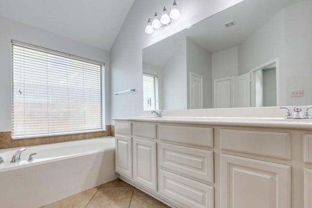 16223 Cotton Grove Ln, Houston, TX 77044 - full bath with vaulted ceiling, double vanity, a bath, and tile patterned floors