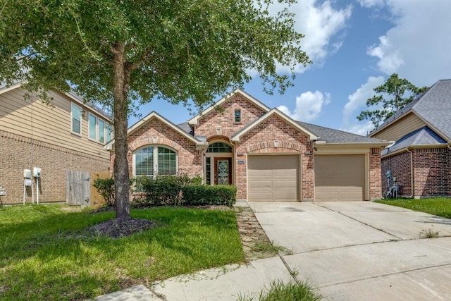 16223 Cotton Grove Ln, Houston, TX 77044 - view of front facade featuring brick siding, driveway, a garage, and a front yard