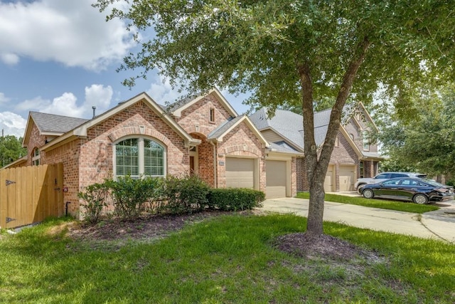 16223 Cotton Grove Ln, Houston, TX 77044 - view of front of home featuring brick siding, concrete driveway, a garage, and roof with shingles