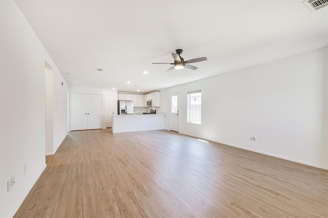 17427 Cyprian Cedar Ln, New Caney, TX 77357 - unfurnished living room with light wood-style flooring, ceiling fan, and recessed lighting