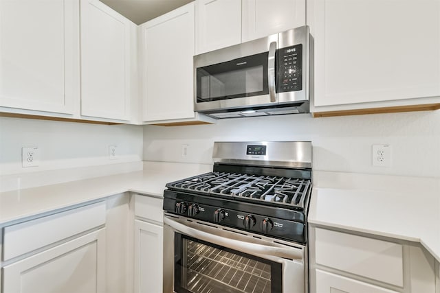 17427 Cyprian Cedar Ln, New Caney, TX 77357 - kitchen featuring stainless steel appliances, white cabinetry, and light countertops