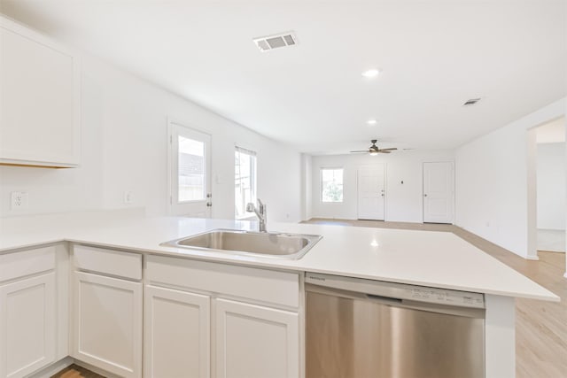 17427 Cyprian Cedar Ln, New Caney, TX 77357 - kitchen with dishwasher, open floor plan, white cabinets, light wood finished floors, and recessed lighting