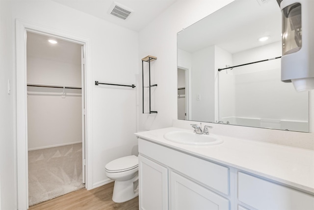 17427 Cyprian Cedar Ln, New Caney, TX 77357 - full bathroom featuring vanity, wood finished floors, a spacious closet, and a shower