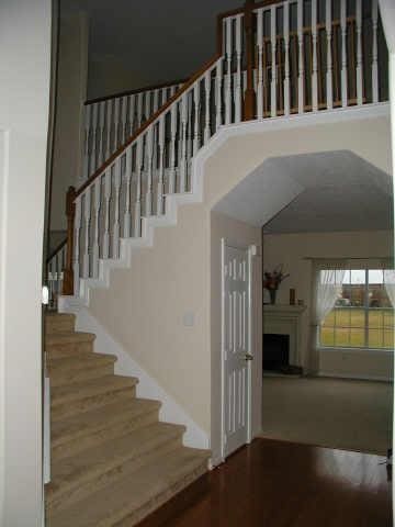 515 Silver Leaf Ct, Pearland, TX 77584 - stairs featuring a fireplace, a towering ceiling, and wood finished floors