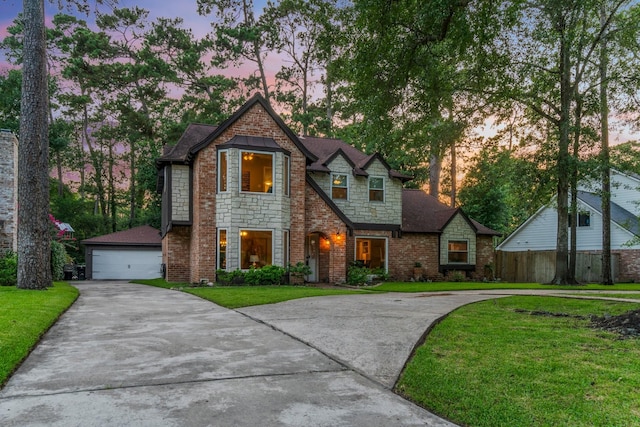 24111 Norchester Way, Spring, TX 77389 - view of front of property featuring a lawn, stone siding, and a detached garage