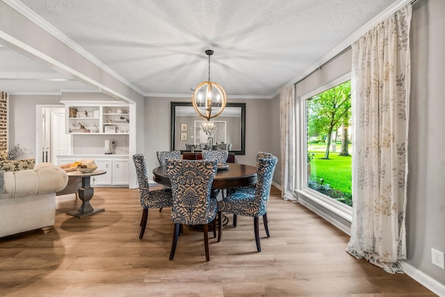 24111 Norchester Way, Spring, TX 77389 - dining space featuring a chandelier, light wood finished floors, crown molding, and a textured ceiling