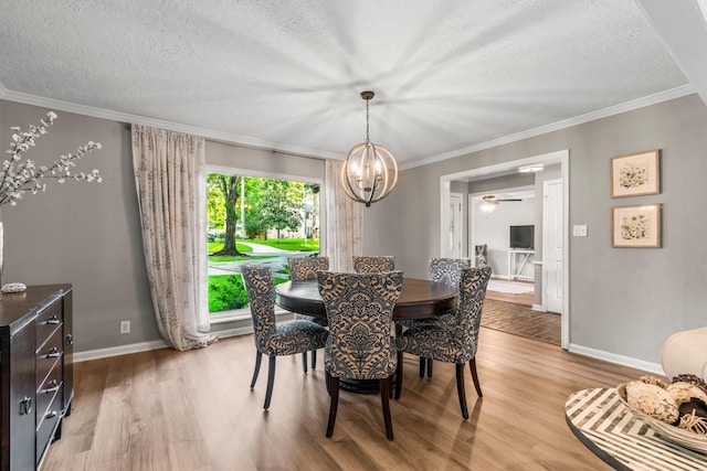 24111 Norchester Way, Spring, TX 77389 - dining room with wood finished floors, a chandelier, a textured ceiling, crown molding, and ceiling fan