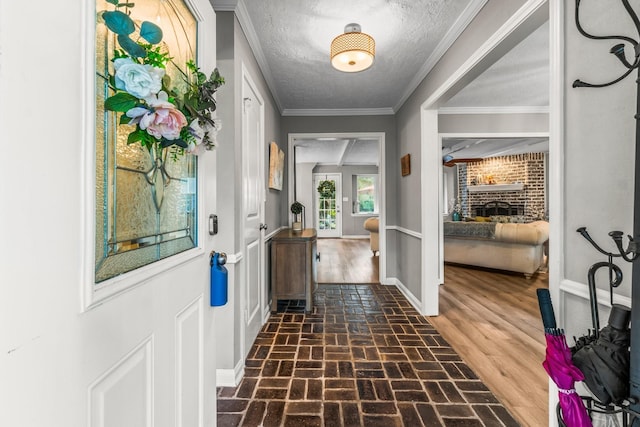 24111 Norchester Way, Spring, TX 77389 - foyer entrance with brick floors, a textured ceiling, and ornamental molding