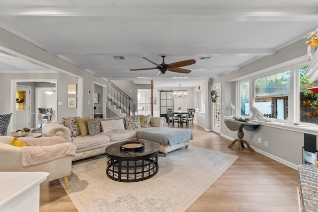 24111 Norchester Way, Spring, TX 77389 - living area with stairs, light wood-style floors, ceiling fan, a chandelier, and beam ceiling