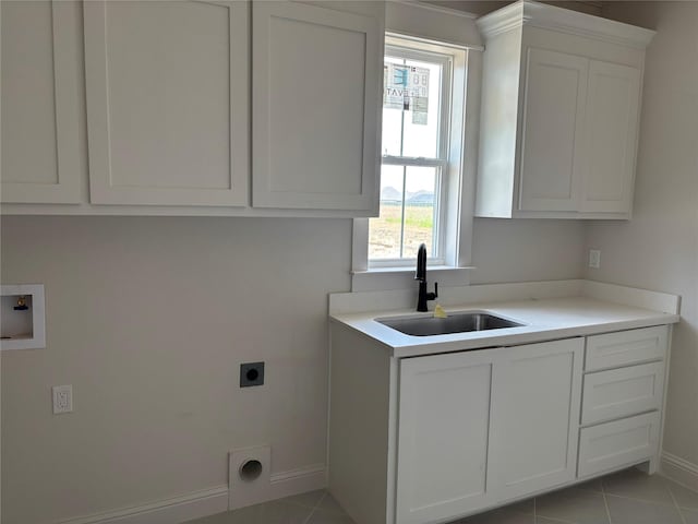 6560 Brayfield, Beaumont, TX 77706 - washroom featuring electric dryer hookup, cabinet space, washer hookup, and light tile patterned floors