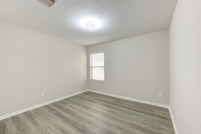 9207 Ranch Ridge Ln, Richmond, TX 77407 - empty room with wood finished floors and a textured ceiling