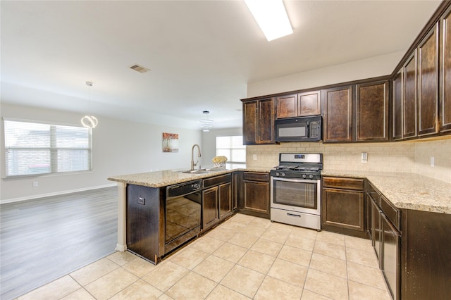 9207 Ranch Ridge Ln, Richmond, TX 77407 - kitchen featuring black appliances, dark brown cabinets, and a peninsula