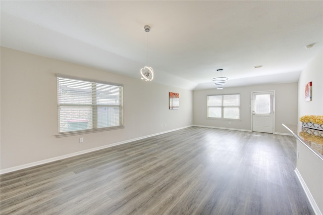 9207 Ranch Ridge Ln, Richmond, TX 77407 - unfurnished living room featuring wood finished floors and baseboards
