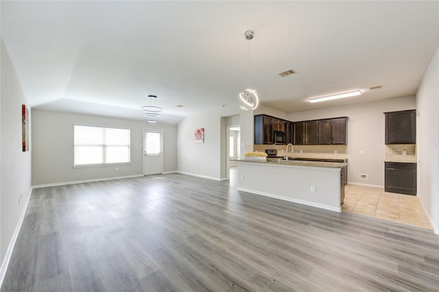 9207 Ranch Ridge Ln, Richmond, TX 77407 - unfurnished living room with light wood-type flooring and baseboards